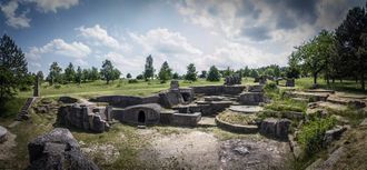 A photo of a settlement built in stone and into the ground.