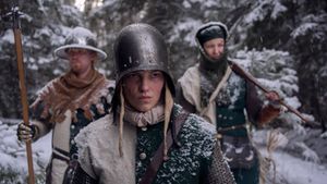 Three Granland Regular Army soldiers standing in a snow covered forest.