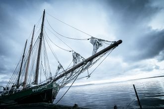 A dutch angle photograph of a ship in port